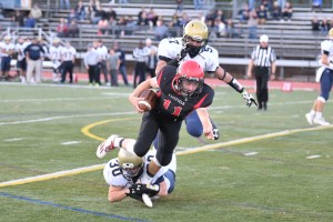 Westfield's Mike Nihill (11) attempts to elude the grasp of Shrewsbury linebacker Ryan Buckley (30) during a Division 2 state semifinal Saturday at Westfield State University. (Photo by Marc St. Onge)