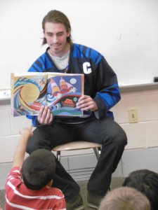 WSU hockey player and business major Jackson Leef, a senior from Indiana, read Langston Hughes poetry to fourth graders at Highland. (Photo by Amy Porter)
