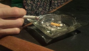 A cigarette sits at the edge of an ashtray (photo credit: Dan Desrochers)