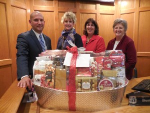 Council president Brent B. Bean, II and Ward 4 Councilor Mary O'Connell present a gift basket to city clerk Karen Fanion (second from left) and assistant clerk Donna Roy (right) in appreciation for their support of the City Council all year. (Photo by Amy Porter)