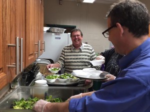 Select Board Chairman Russ Fox is all smiles as Select Board Vice-Chairman Doug Moglin and Clerk Joe Deedy help prepare the salad for the seniors. (Photo by Greg Fitzpatrick)