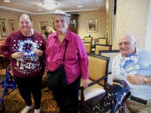 Arbors residents Geraldine Olinski, Jean Deon and Cam Chasse show off their handmade wreaths. (Photo by Amy Porter)