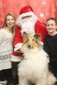 Katelyn and Jeffrey Horky pose with Sophie and Santa Claus.