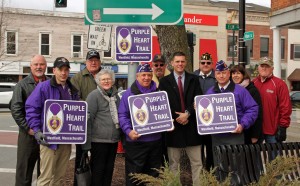 Several were on hand for the unveiling of the first portion of the Purple Heart Trail. From left to right: Mayor Brian Sullivan, Tommy Prasenski, Scott Thomas, recipient of two Purple Hearts, Jane Wensley, John Hurley, Frank G. Mills II, John Velis, Dennis Yefko, Brian Willette, Mary O'Connell, and Jim Parker, recipient of three Purple Hearts. (Phot Credit: Don Wieglus)