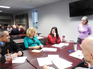Kate Phelon, executive director of the Greater Westfield Chamber of Commerce (standing), listens to group discussions at the meeting. (Photo by Amy Porter)