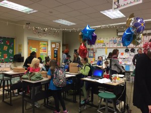 Third grade students look at their new standing desks and their Reebok sneakers, along with their parents. (Photo by Greg Fitzpatrick)