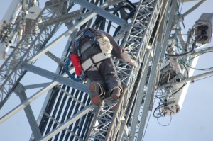 A worker from Goosetown Communications in Congers, New York, climbs down a Westfield radio tower while tethered with a bungee cord. (Photo credit: Peter Cowles)