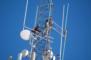 A worker from Goosetown Communications from Congers, New York, works high above Westfield on one of the radio towers. (Photo credit: Peter Cowles)
