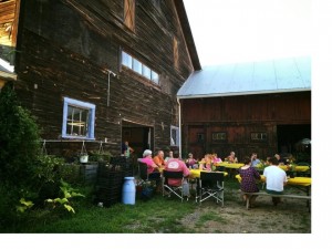 Yellow Stonehouse Farm CSA members enjoy a potluck supper last summer outside of the 1840 barn.