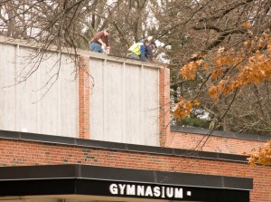 Work crews are atop the gymnasium of Westfield High School to address and repair areas of the roof that were found to be leaking into the facility below (Photo by Lynn Boscher).