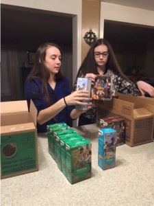 Sisters Heather and Morgan O'Connor check their inventory of Girl Scout cookies.