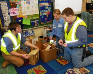 Construction Tech senior Alex Sparks and freshmen Rachael Cyrankowski and Bailey Ala prepare to demonstrate how to build a birdhouse to first graders at Southampton Road School on Thursday. (Photo by Amy Porter)