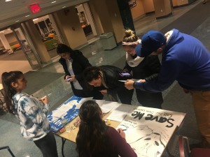 Students gather around a table set up by MASSPIRG and learn information about the project (photo provided by Kane Sheek)