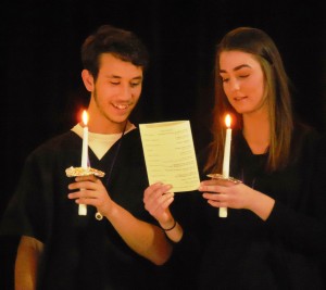 Jaisen Gomez and Ilona Gladysh recite the CNA pledge with their candles lit. (Photo by Amy Porter(