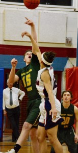 Southwick’s Billy Strain, left, leaps for the opening tip in Monday night’s tournament opener at Mahar Regional High School in Orange. (Photo by Chris Putz)