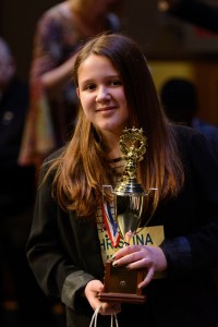 Christina Marini holds her first place trophy after winning the Words with Friends Spelling Bee