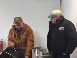 Leon Ripley shows Lebeaux part of the process they go through with making their maple syrup. (Photo by Greg Fitzpatrick)