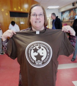 Southampton Road Elementary School Principal Kathleen O'Donnell holds up the school's logo t-shirt, designed by WTA Graphic Arts.