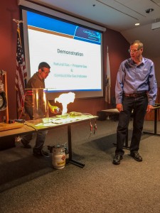Southwick firefighter Steven Pinette ignites a gas sample with Madison during the demonstration. (Photo from Southwick Fire Department)