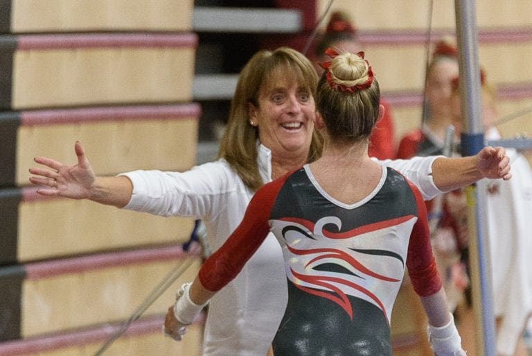 WHS gymnastics coach's undefeated streak comes to an end The